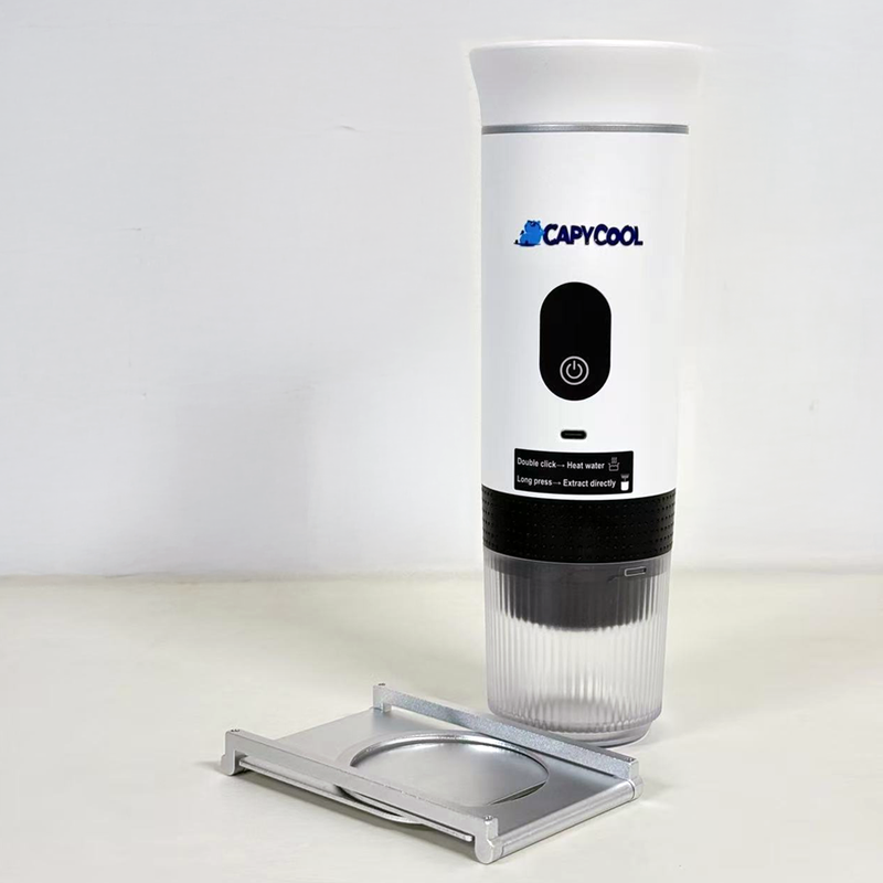 White CapyCool portable coffee machine with black base, power button, and silver drip tray.