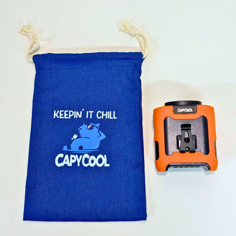 Blue Capycool Chill Bag drawstring pouch with "Keepin' It Chill" capybara graphic, next to an orange Capycool fan.