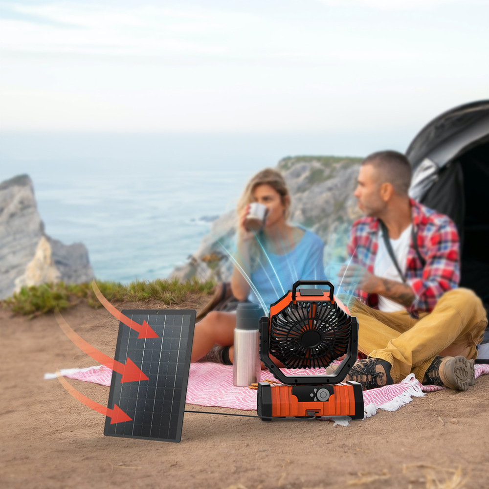 Portable camping fan cooling a couple outdoors