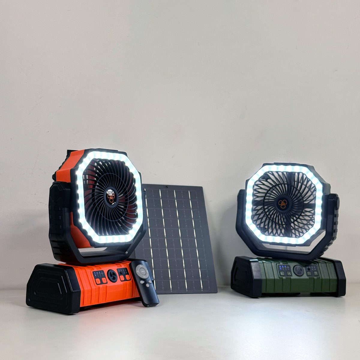 Two portable outdoor camping fans with LED lights and solar panel